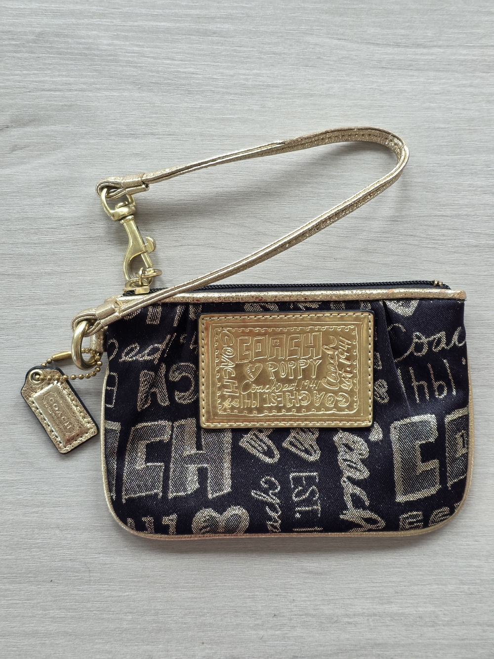 Coach Metallic Script Wristlet in Black and Gold